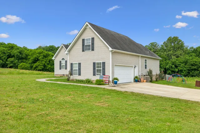 a living room with furniture and a book shelf