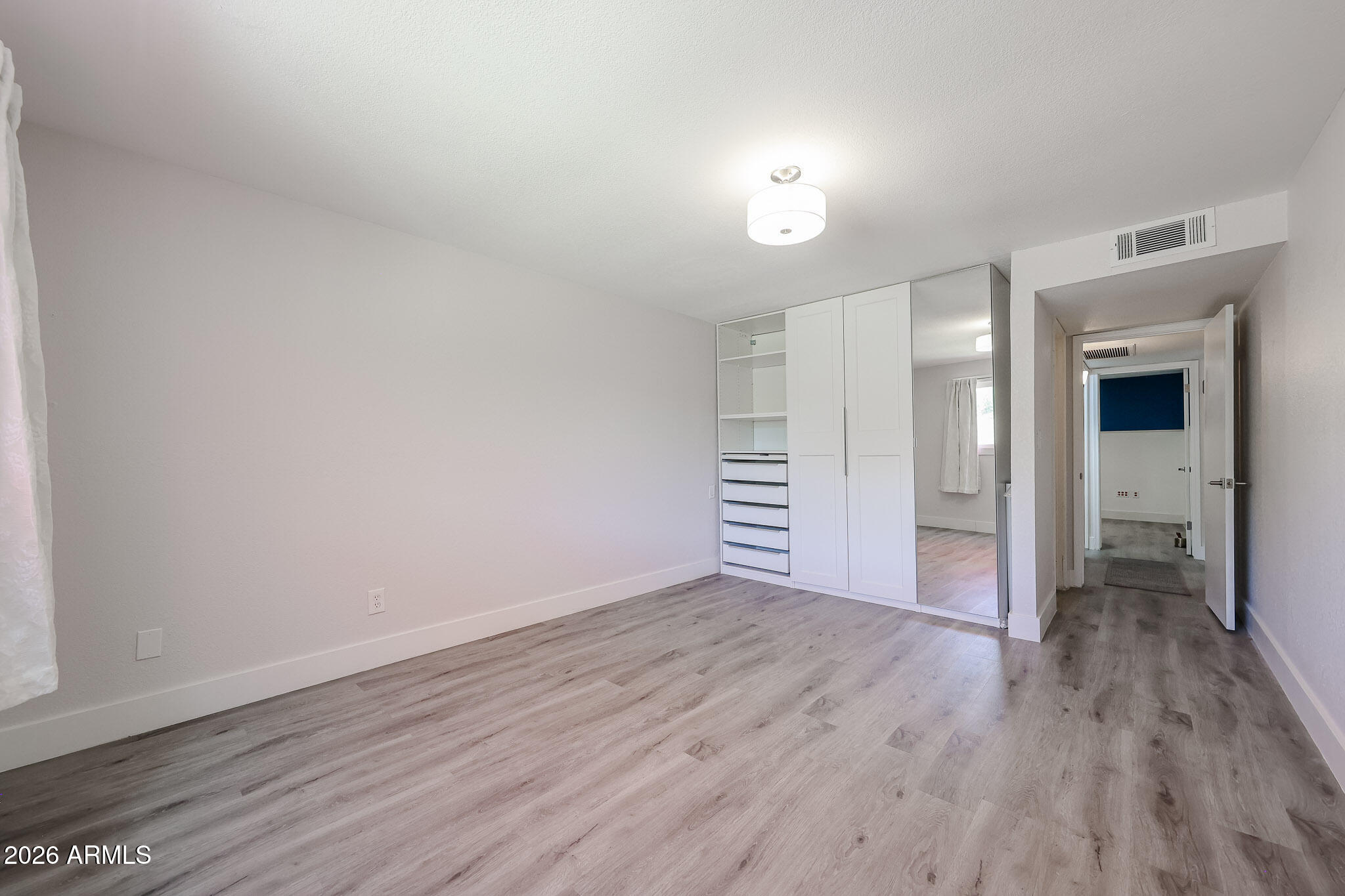 5114 East Monte Vista Road Phoenix, AZ 85008 - Photo 5 of 45 a view of an empty room with wooden floor
