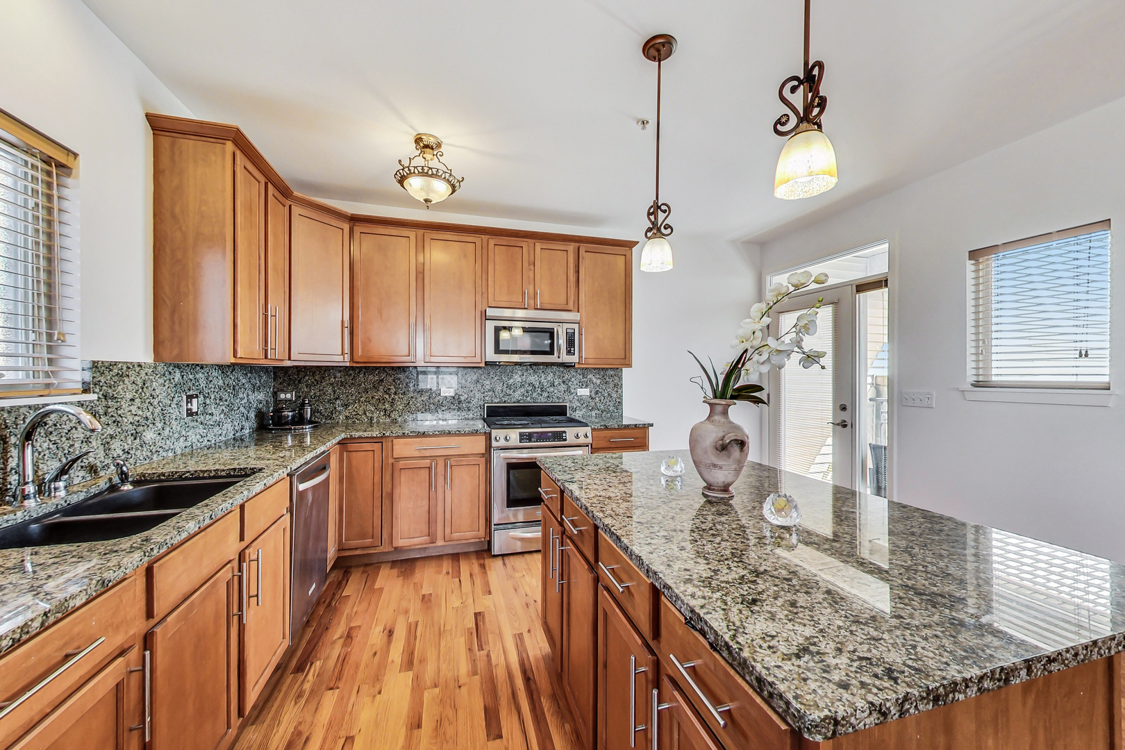 45 East 23rd Street Chicago, IL 60616 - Photo 10 of 27 a kitchen with stainless steel appliances granite countertop a sink stove and refrigerator
