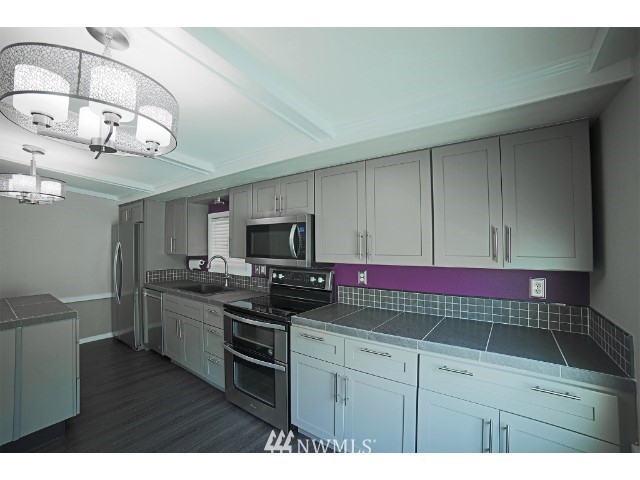 2500 South 370th Street, Unit 12 Federal Way, WA 98003 - Photo 15 of 40 a kitchen with stainless steel appliances cabinets a sink and a stove