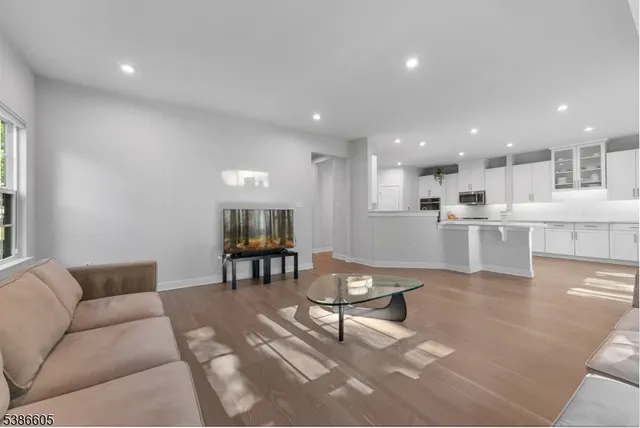 a living room with furniture and kitchen view