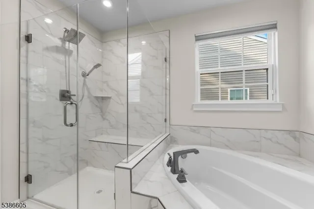 a white bath tub sitting next to a shower