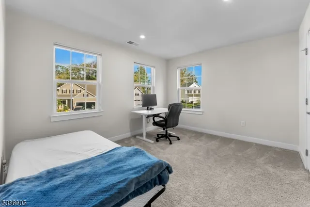 a bedroom with a bed a desk and chair