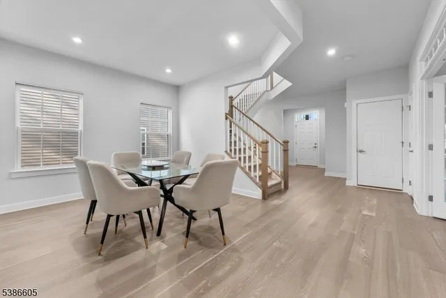 a dining room with furniture and wooden floor