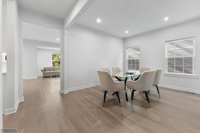a dining room with furniture and wooden floor
