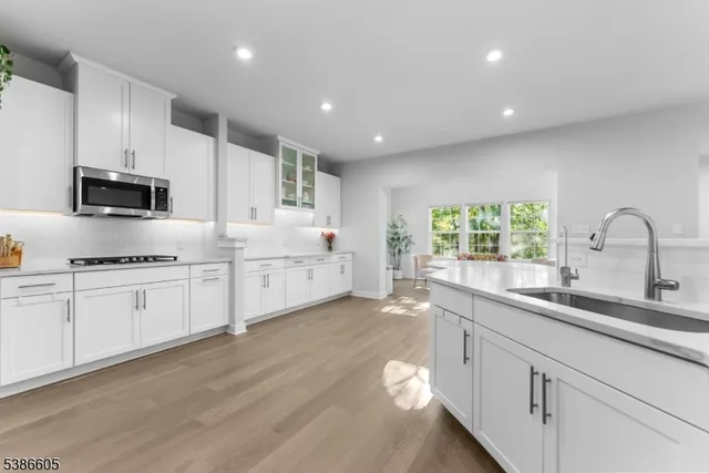 a kitchen with appliances a sink and cabinets