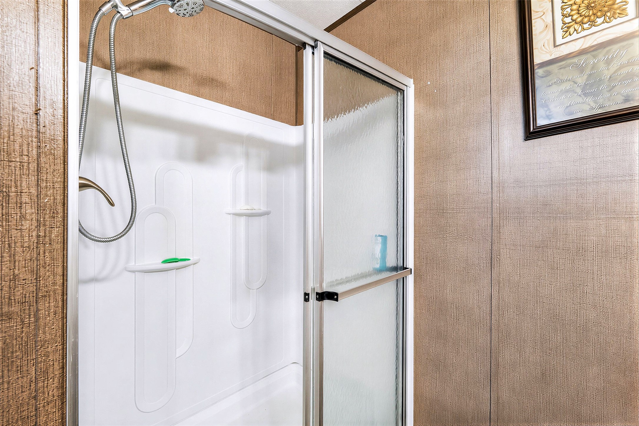 935 Lower Red Rock Road Bastrop, TX 78602 - Photo 15 of 25 Primary bathroom featuring a convenient handheld showerhead and built-in shelving.
