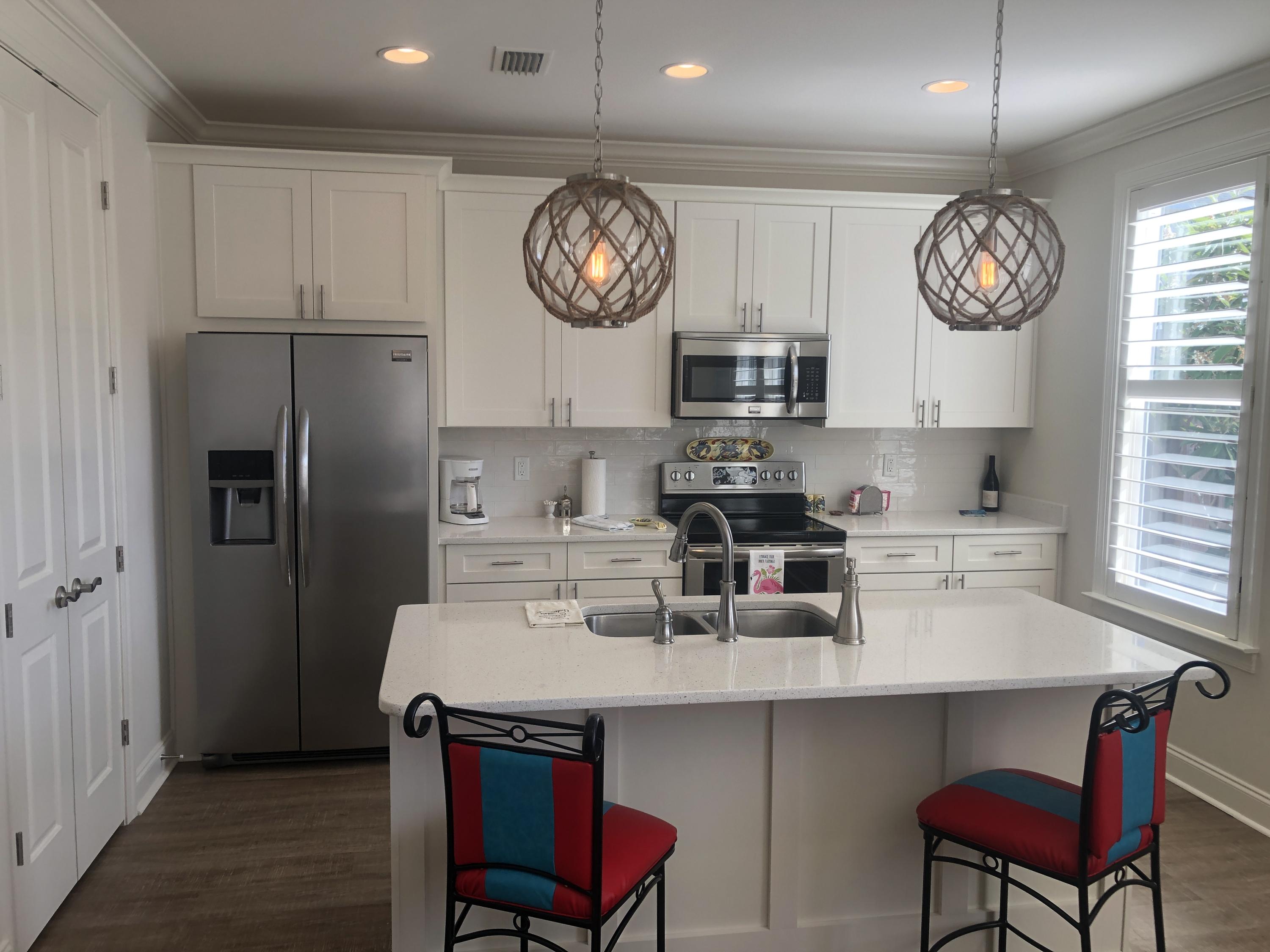 52 Chapman Street Santa Rosa Beach, FL 32459 - Photo 14 of 50 a kitchen with cabinets and stainless steel appliances