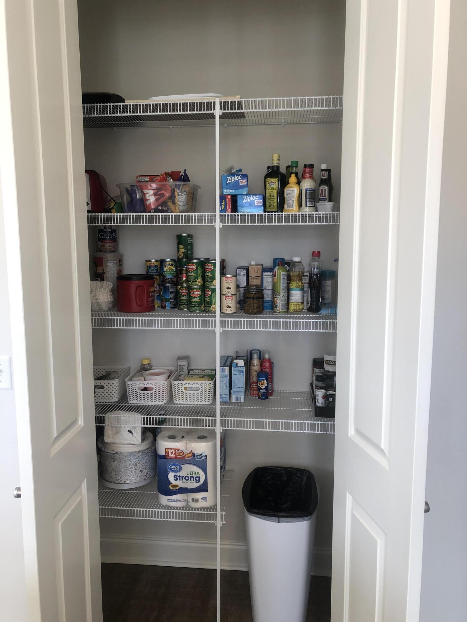 52 Chapman Street Santa Rosa Beach, FL 32459 - Photo 16 of 50 a room with a lot of white cabinets and a wooden floor