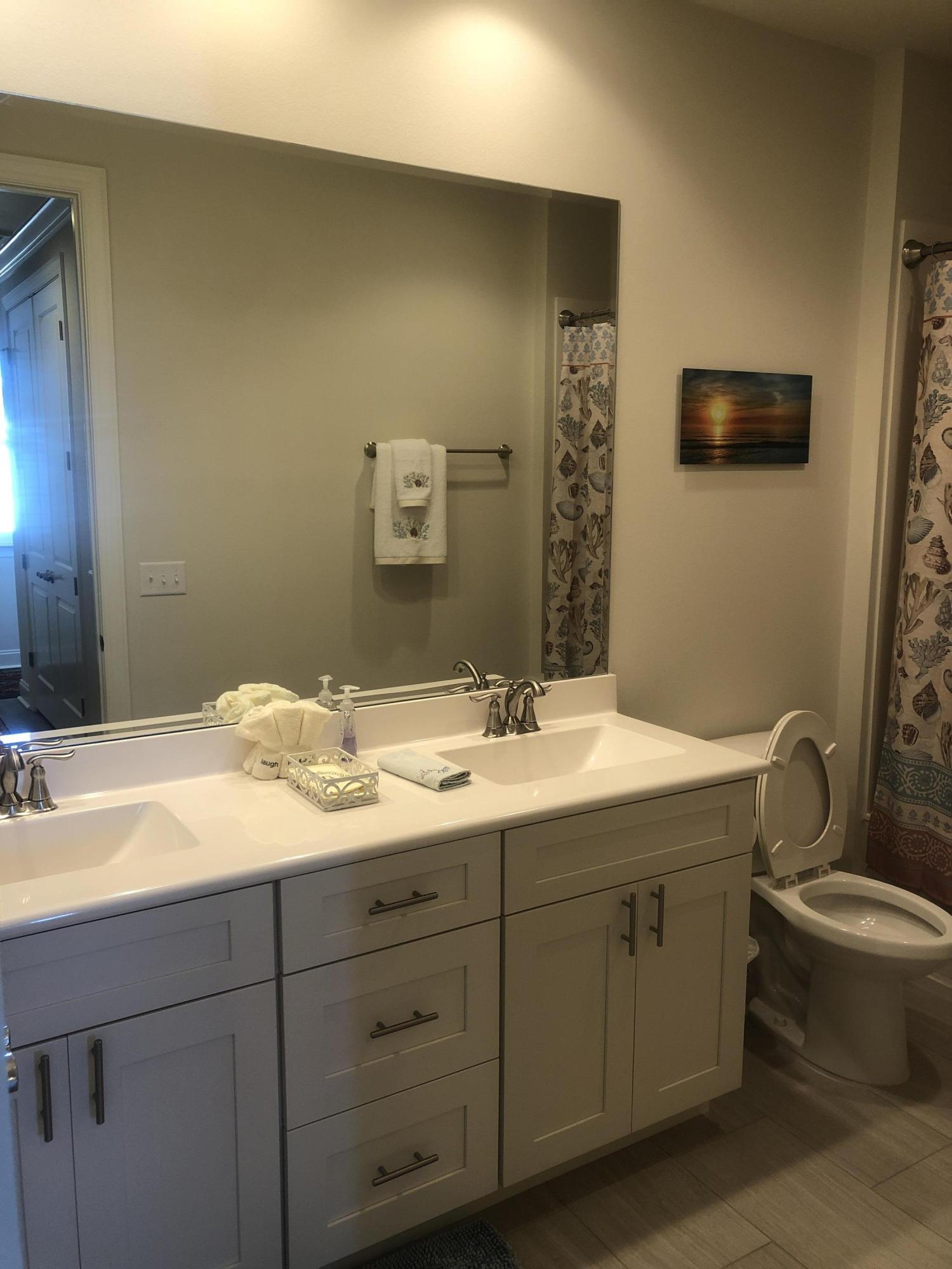 52 Chapman Street Santa Rosa Beach, FL 32459 - Photo 30 of 50 a bathroom with a granite countertop sink mirror and toilet
