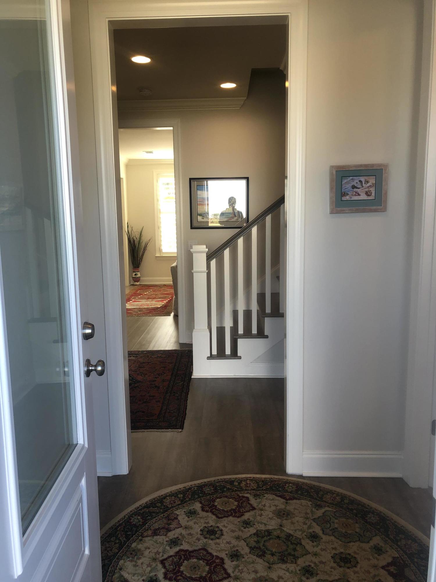 52 Chapman Street Santa Rosa Beach, FL 32459 - Photo 4 of 50 a view of a hallway with wooden floor and staircase