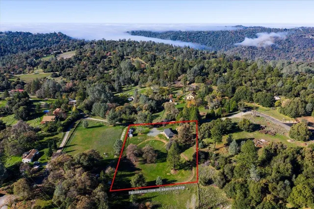 an aerial view of a houses with a street