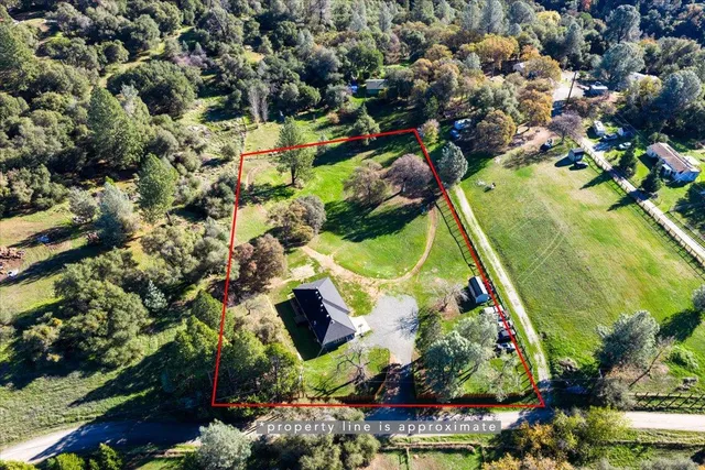 an aerial view of a residential houses with outdoor space