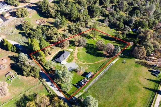 an aerial view of a residential houses with outdoor space