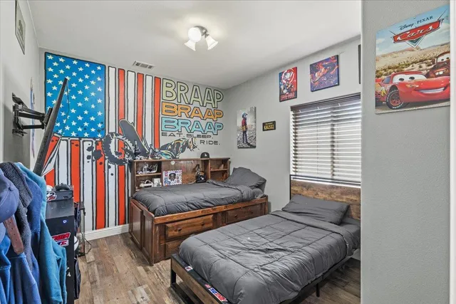 a bedroom with furniture and a large window