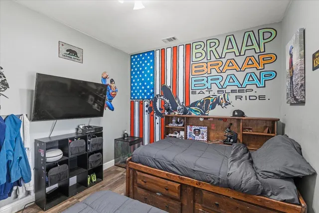 a bedroom with a bed and a flat screen tv