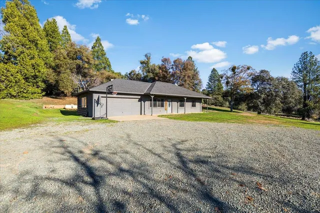 a view of a house with swimming pool and a yard