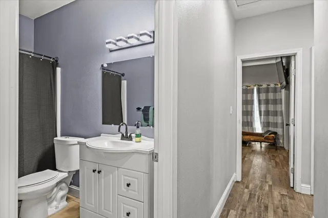 a bathroom with a toilet a sink and a mirror