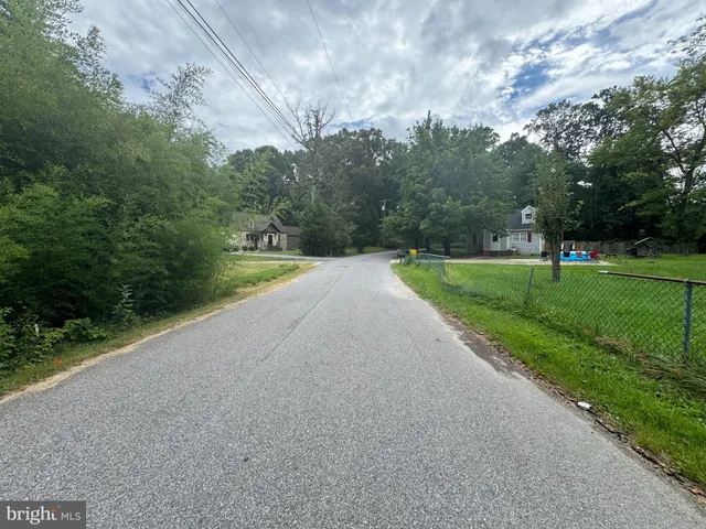a view of road with grass and trees