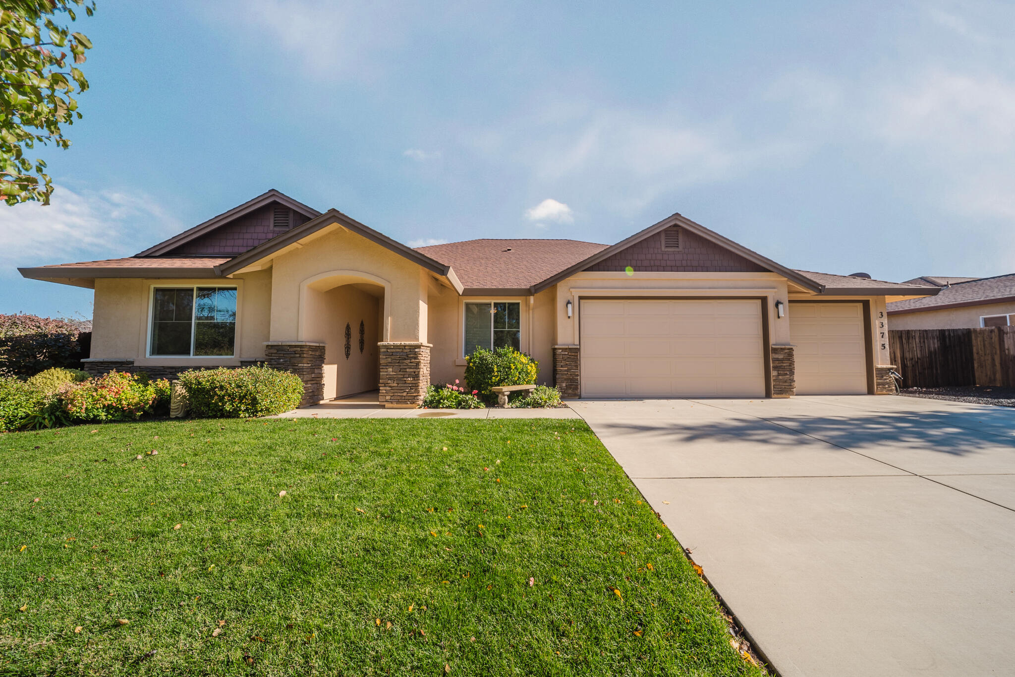 3375 Karuk Avenue Redding, CA 96002 - Photo 1 of 41 a front view of a house with a garden and yard
