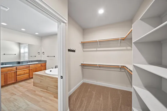 a view of a kitchen with a refrigerator a sink dishwasher and a stove with wooden floor