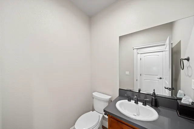a bathroom with a toilet a sink and mirror