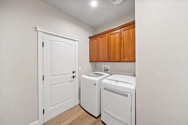 a view of a storage and utility room with washer and dryer