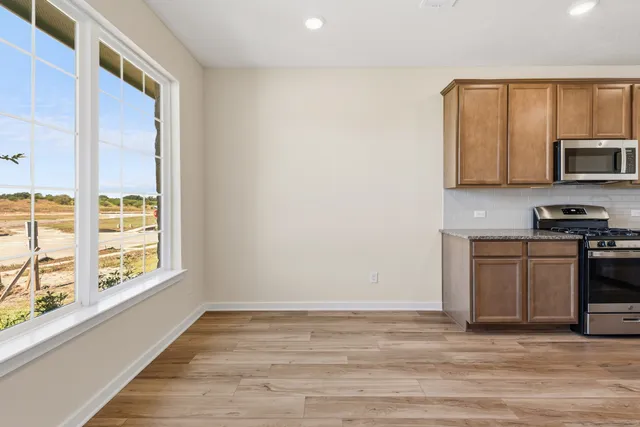 a view of a kitchen with a sink microwave and cabinets