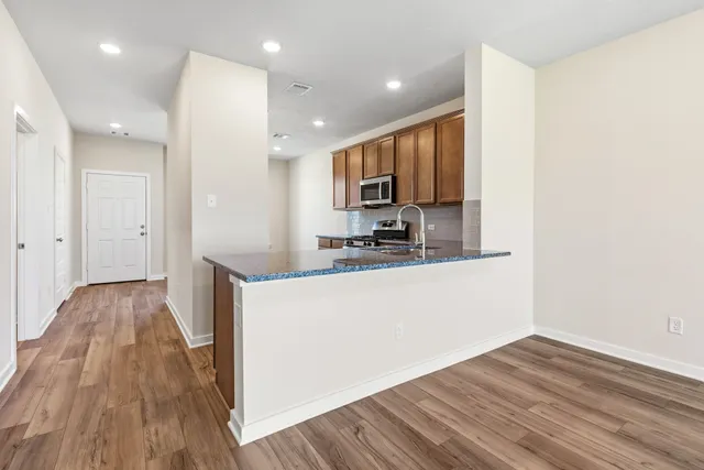 a view of kitchen and wooden floor