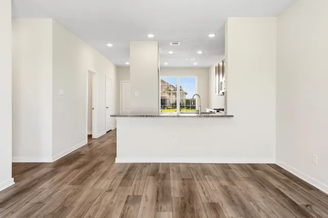 a view of kitchen with cabinets and wooden floor