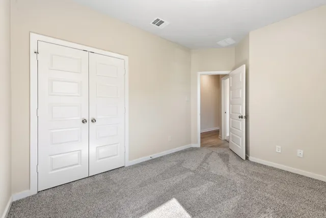 an empty room with closet area