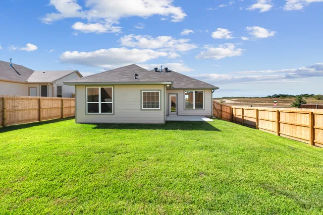a view of a house with a backyard