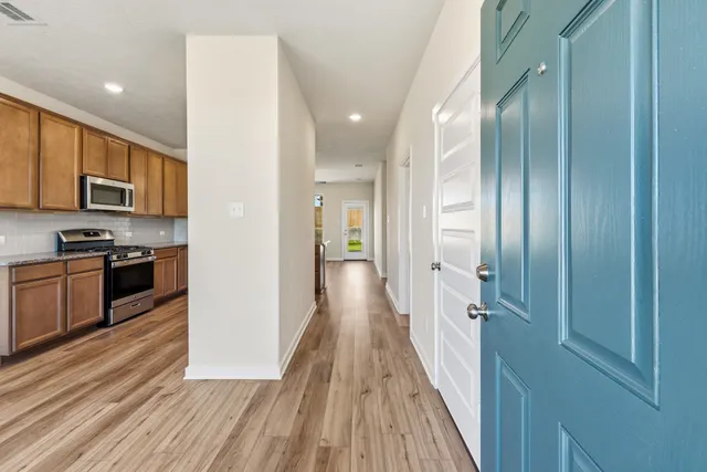 a view of a kitchen with a sink and microwave