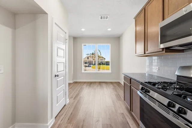 a kitchen with a stove and a microwave