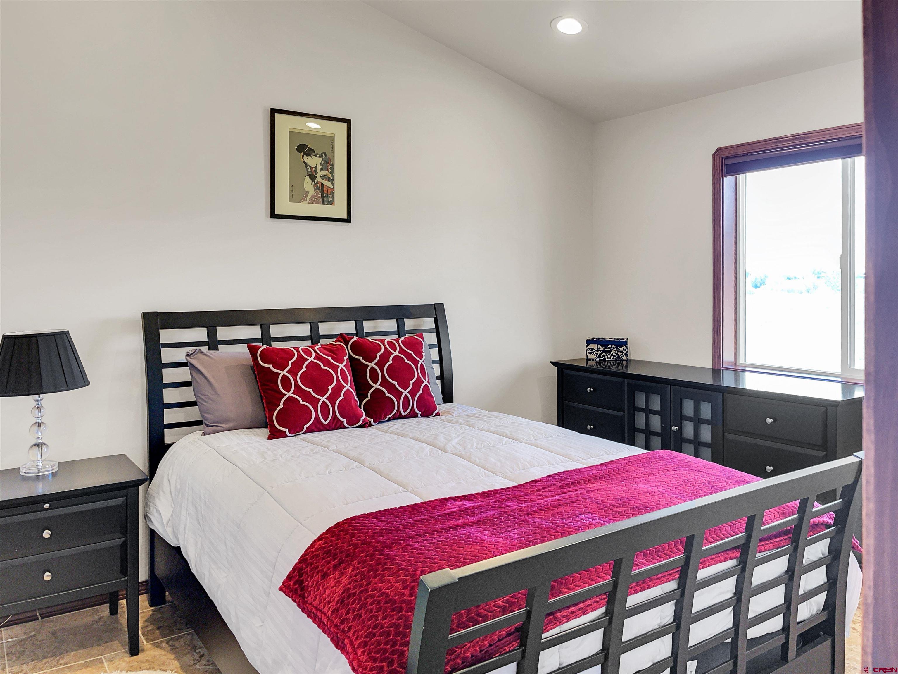 12336 Road 23.25 Loop Cortez, CO 81321 - Photo 12 of 34 a bedroom with a bed and a dresser