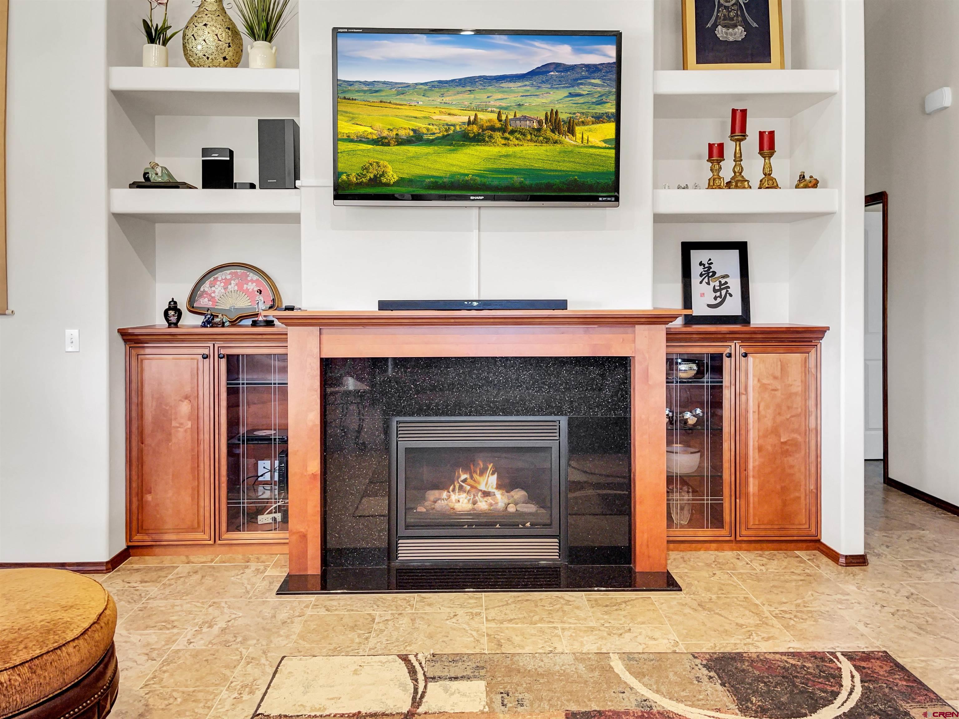 12336 Road 23.25 Loop Cortez, CO 81321 - Photo 13 of 34 a living room with a fireplace and a flat screen tv