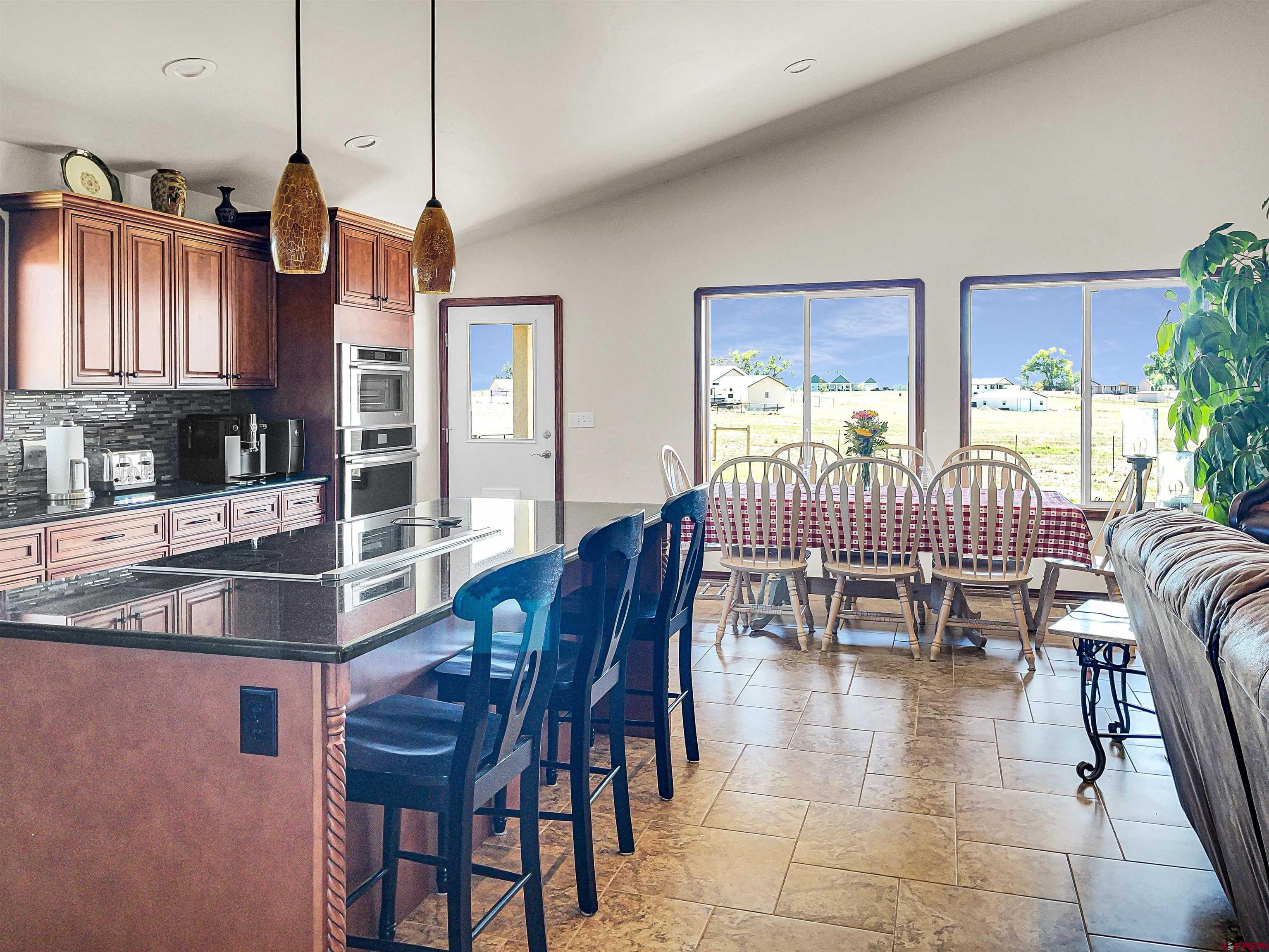 12336 Road 23.25 Loop Cortez, CO 81321 - Photo 19 of 34 a dining room with furniture a chandelier and window