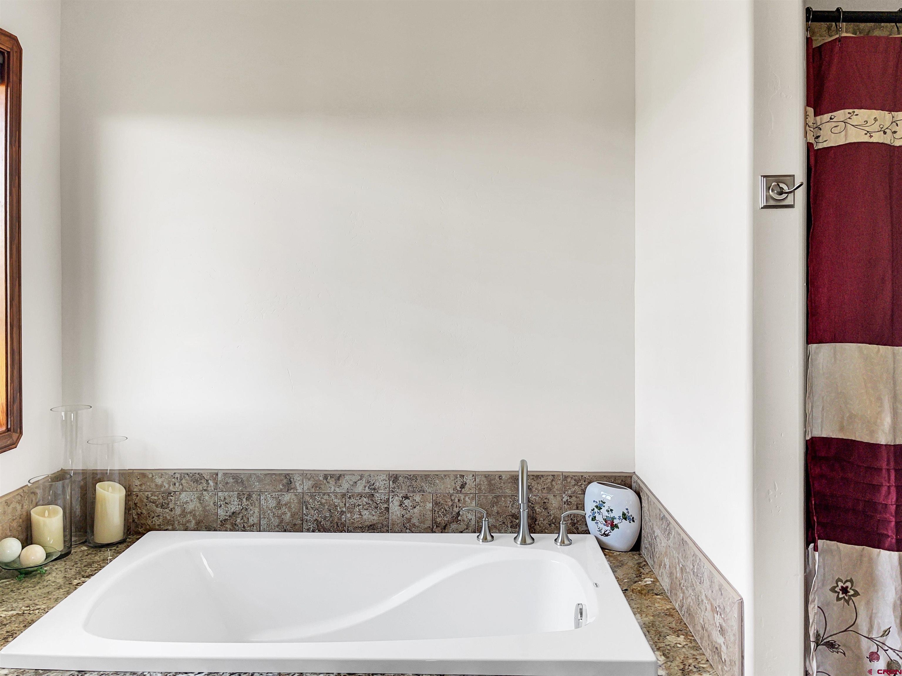 12336 Road 23.25 Loop Cortez, CO 81321 - Photo 23 of 34 a bathroom with a bathtub