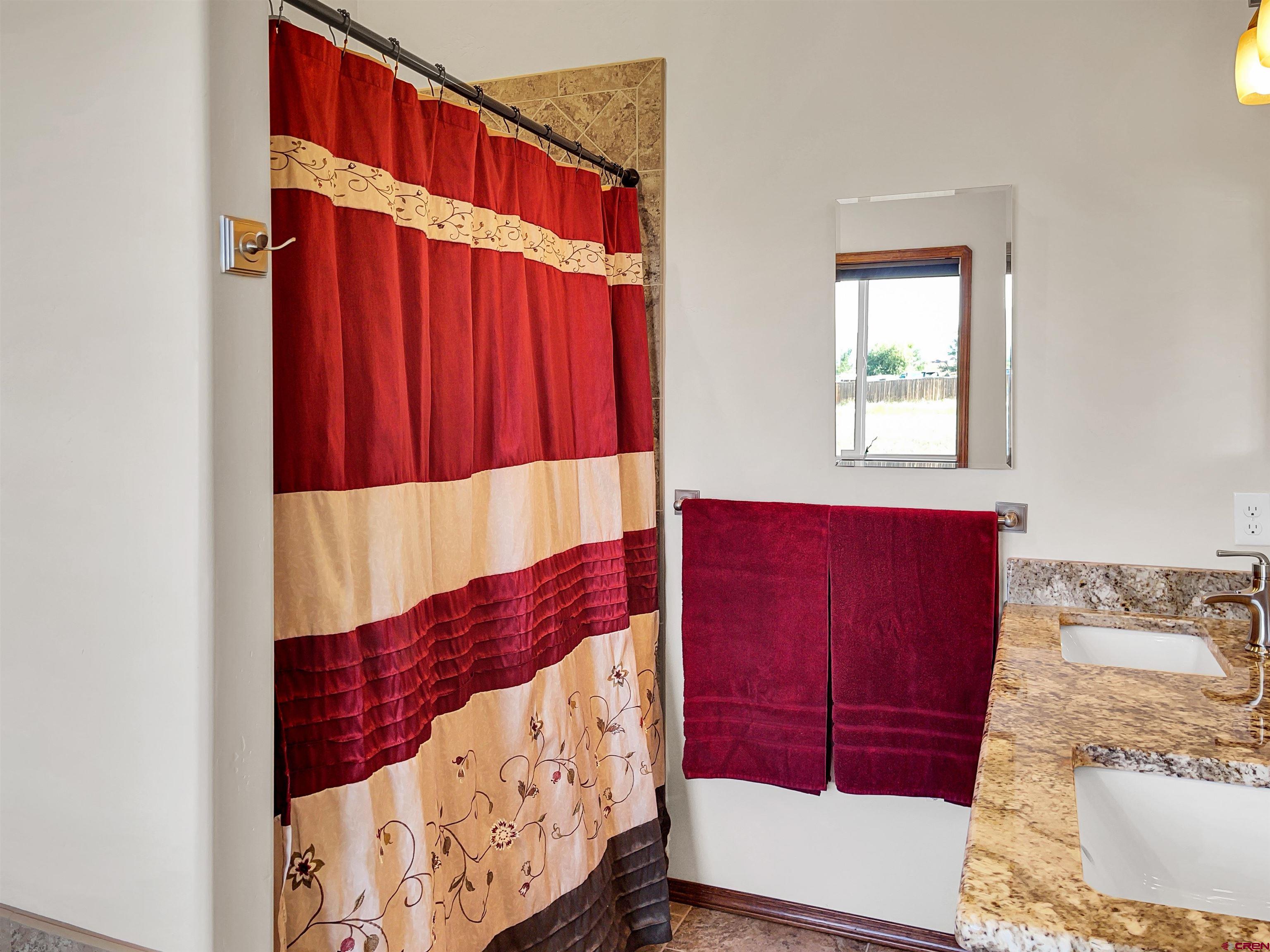 12336 Road 23.25 Loop Cortez, CO 81321 - Photo 24 of 34 a view of a bedroom with a bed and window