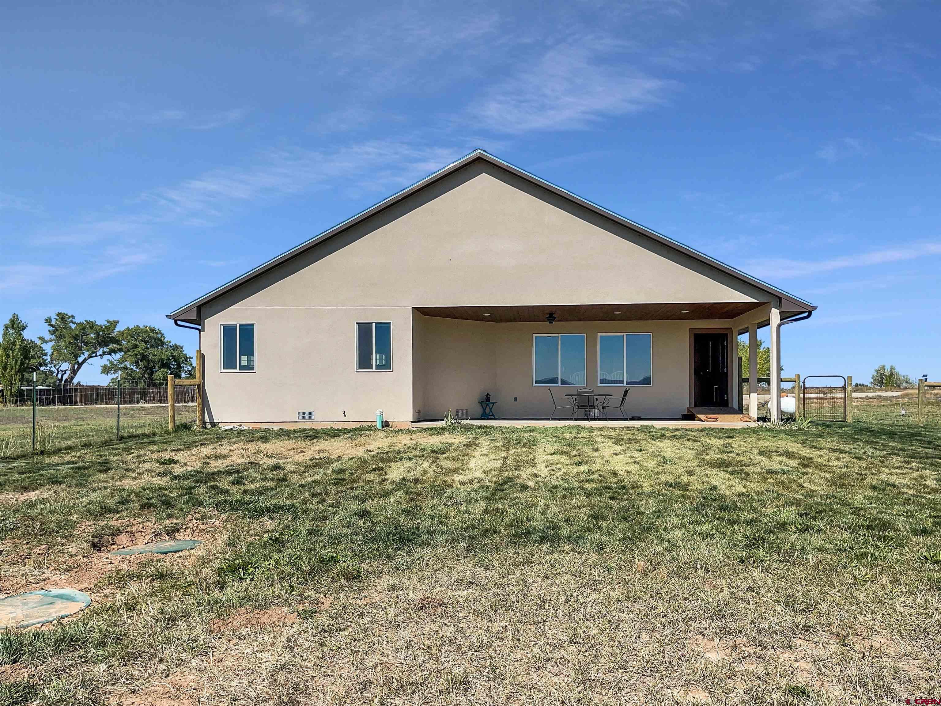 12336 Road 23.25 Loop Cortez, CO 81321 - Photo 27 of 34 a view of a house with a yard