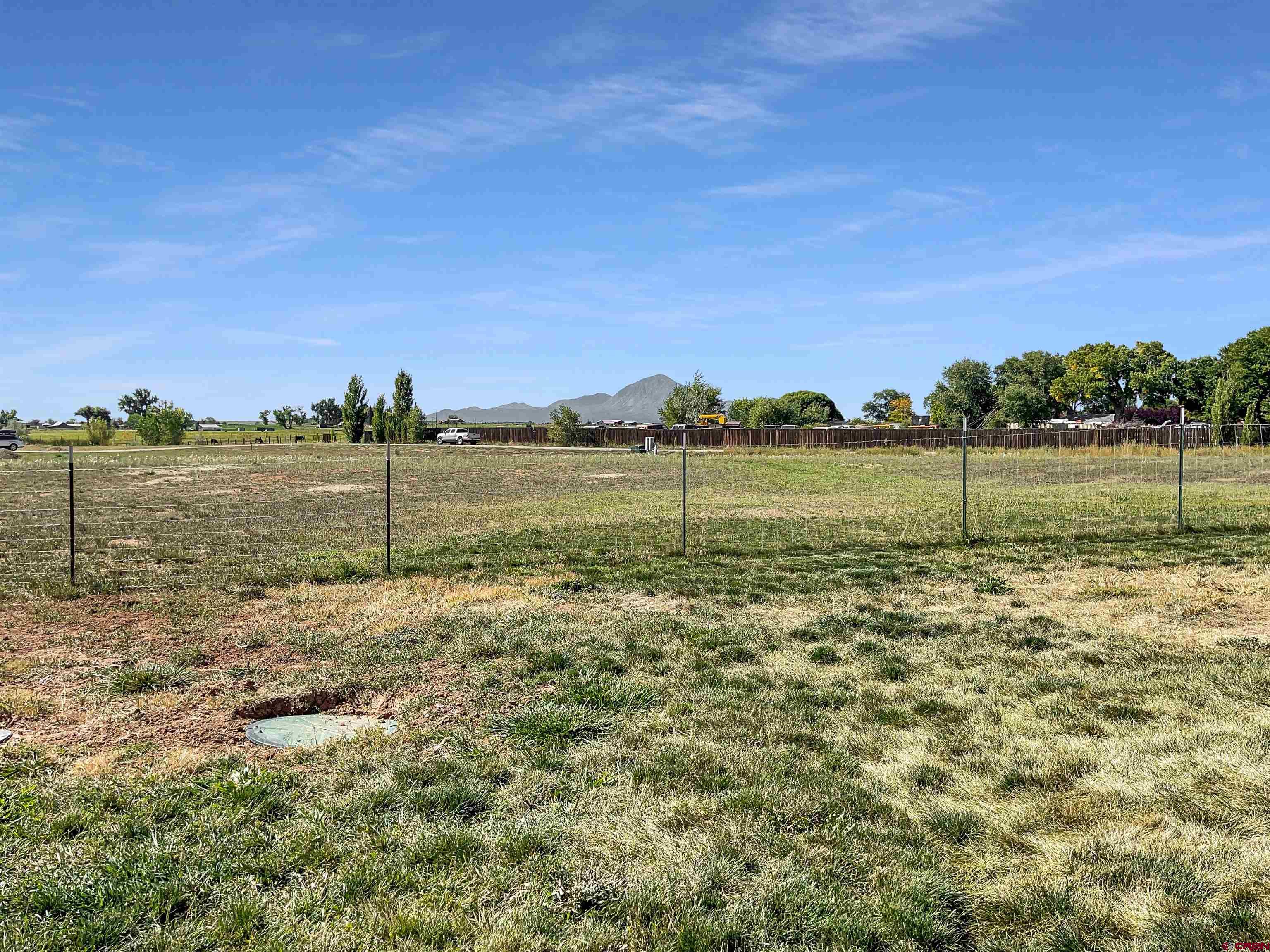 12336 Road 23.25 Loop Cortez, CO 81321 - Photo 33 of 34 a view of a lake with houses in the back