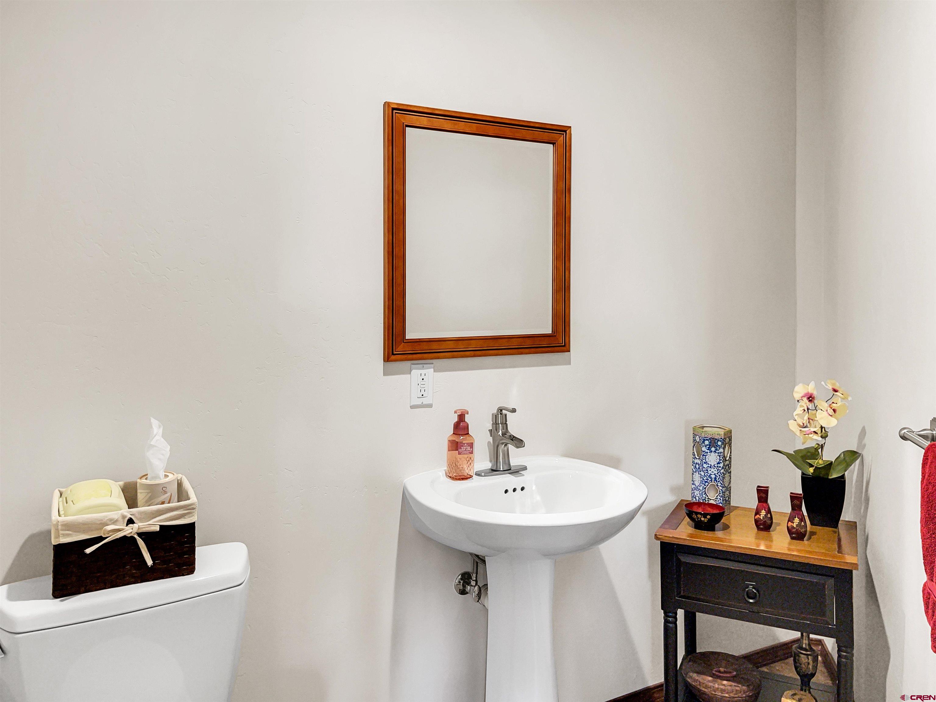 12336 Road 23.25 Loop Cortez, CO 81321 - Photo 7 of 34 a bathroom with a sink mirror and toilet