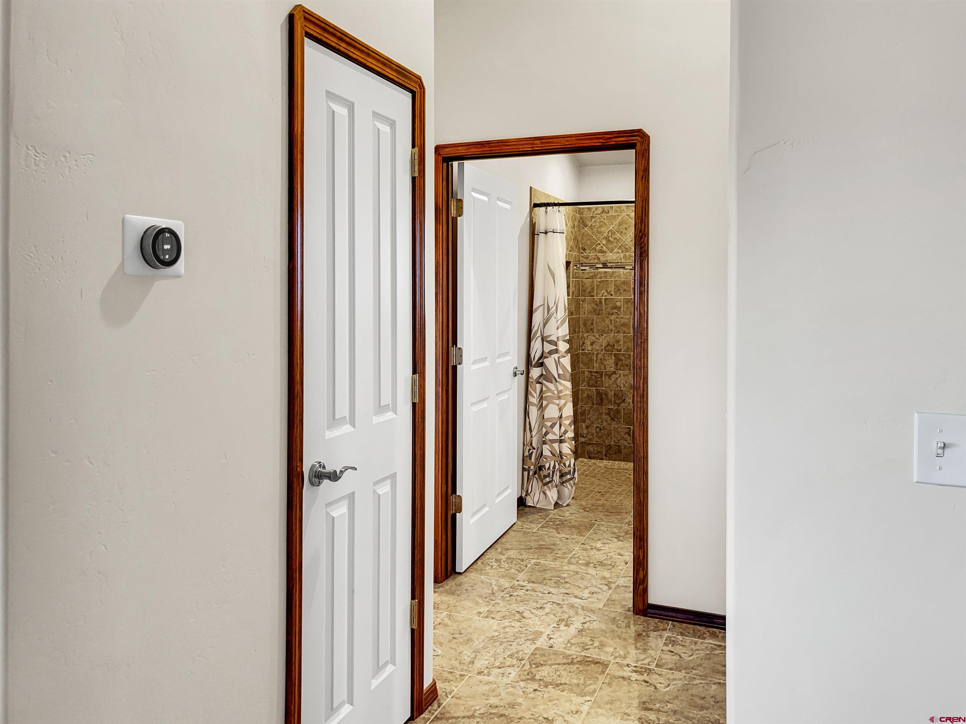 12336 Road 23.25 Loop Cortez, CO 81321 - Photo 10 of 34 a view of a hallway with wooden floor and a bathroom
