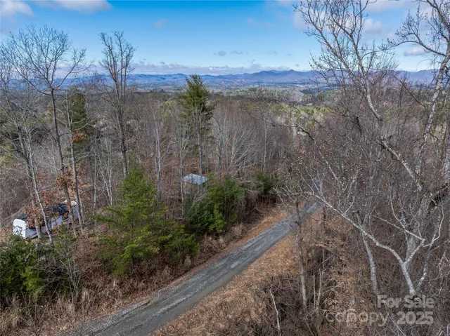 a view of a yard with wooden fence