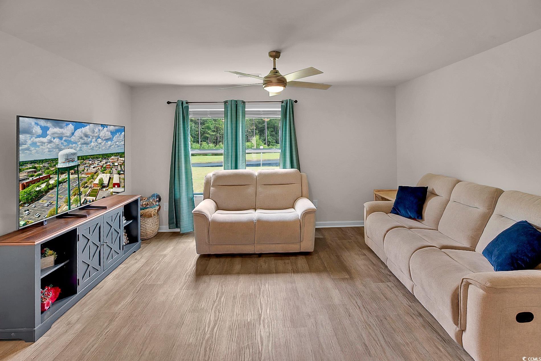 772 Planters Moon Drive Galivants Ferry, SC 29544 - Photo 13 of 39 Living area featuring light wood-style floors and a ceiling fan