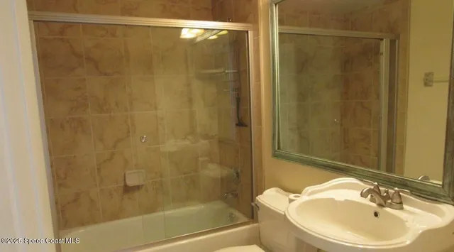 a bathroom with a shower and a sink