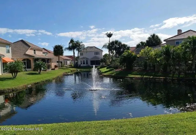 a sign broad in front of yellow house