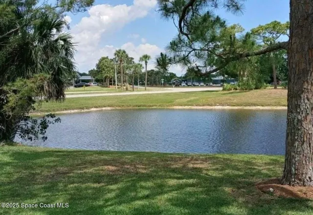 a view of a patio with a table and chairs and potted plants