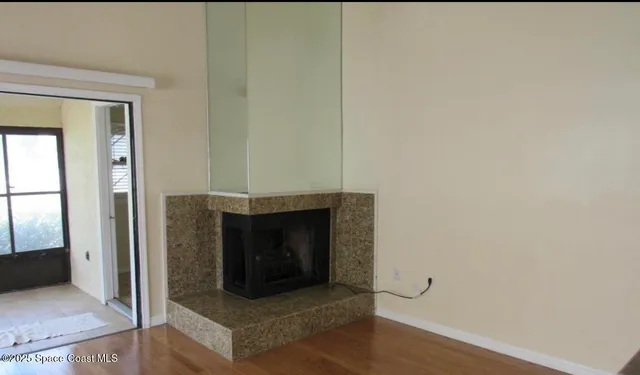 a living room with a fireplace and a wooden floor