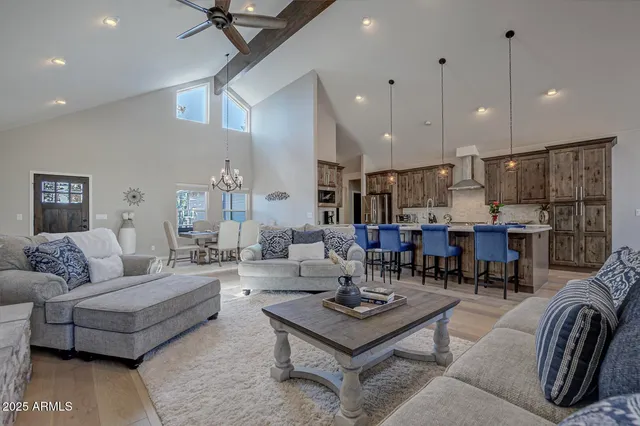 a living room with lots of furniture and kitchen view
